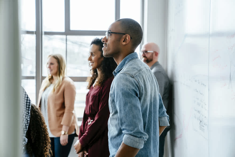 group of employees standing in a meeting