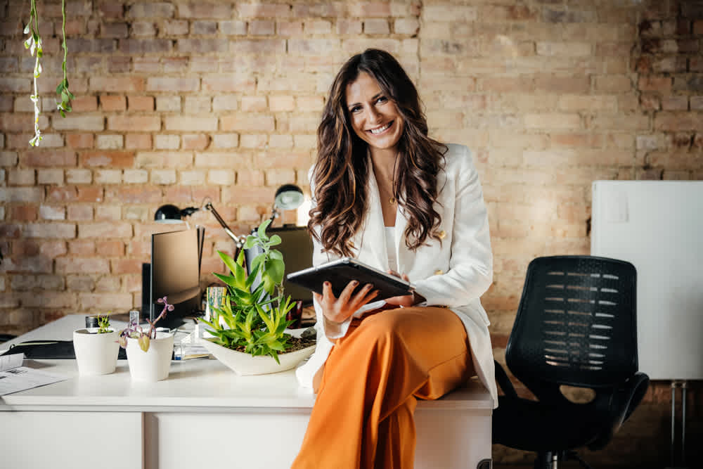 Woman in orange pants white blouse