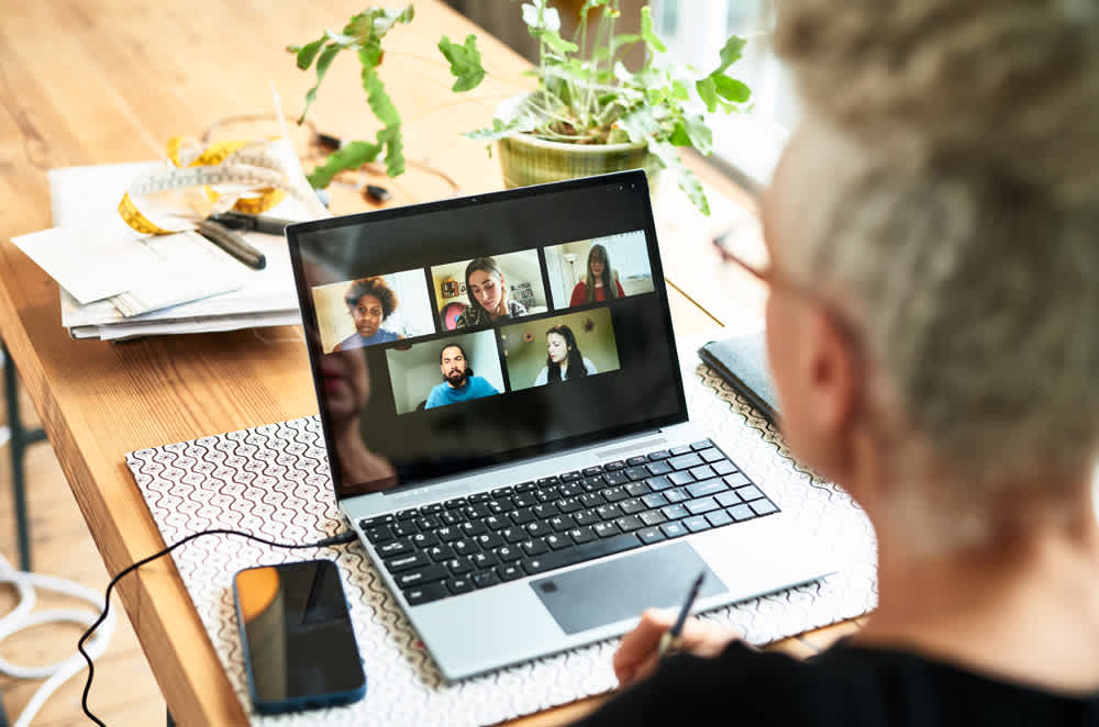 Man working on laptop in a videoconference