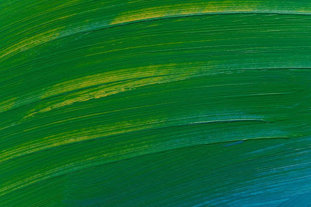 Abstract painting with bold green and blue brushstrokes, accented by streaks of yellow. The textured strokes create a dynamic sense of movement across the canvas.