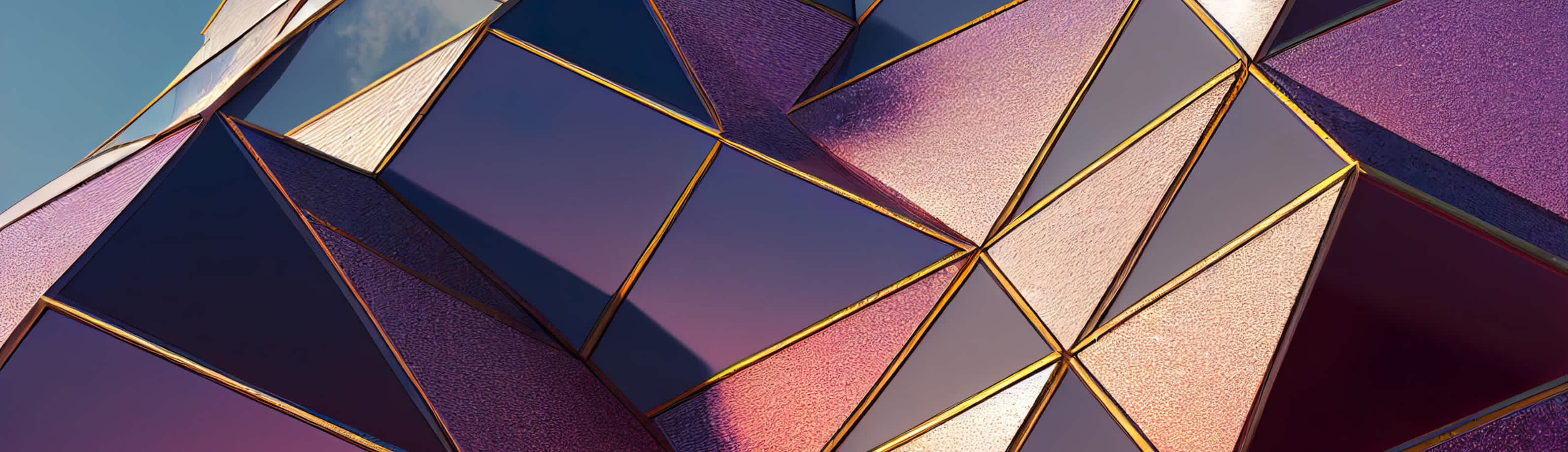 Close-up view of a geometric building facade with triangular and diamond-shaped panels. The panels are reflective, showing a blend of pink, purple, and blue hues with gold borders. The sky is visible in the reflection, giving a dynamic, modern look.