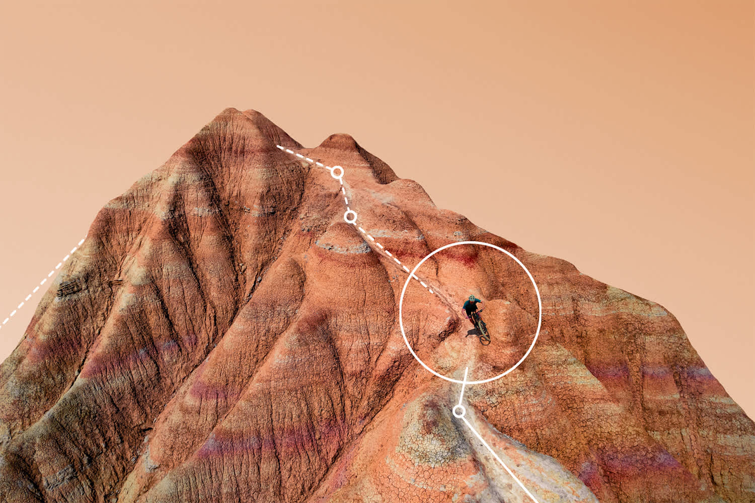 A person rides a bicycle on a rugged, reddish mountain with abstract white lines and circles digitally added over the scene against a peach-colored sky.