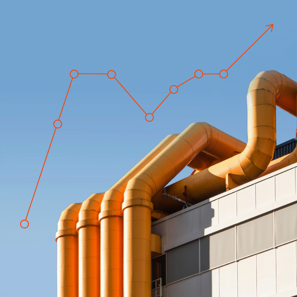 Orange industrial pipes with a red upward trend line chart overlay on a clear blue sky