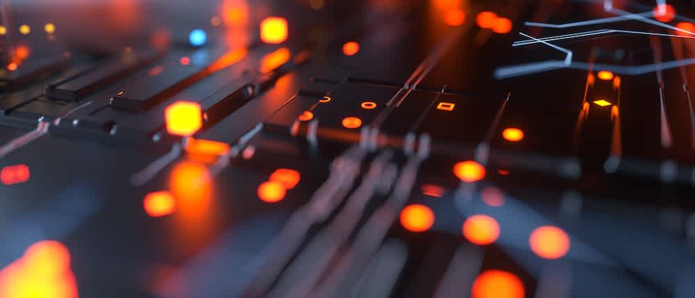 A close-up view of a dark, abstract circuit board with glowing orange and red lights, creating a futuristic and technological atmosphere.