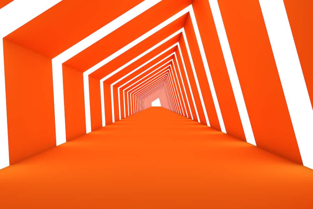 A geometric tunnel with orange walls and white illuminated lines, creating a repeating triangular pattern that leads the eye toward a bright exit in the distance.