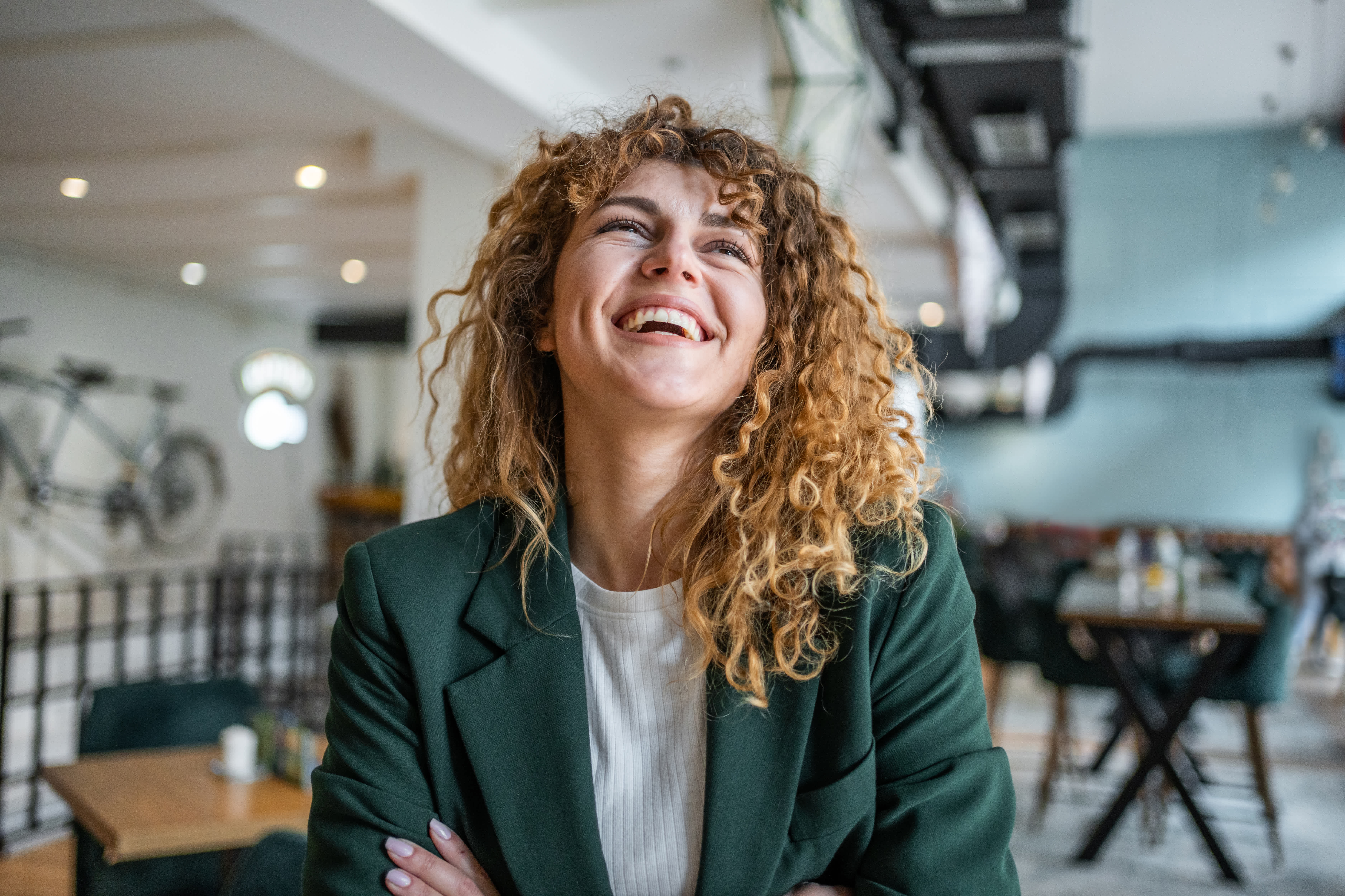 Black man in khaki jacket dancing in copy room with headphones 
