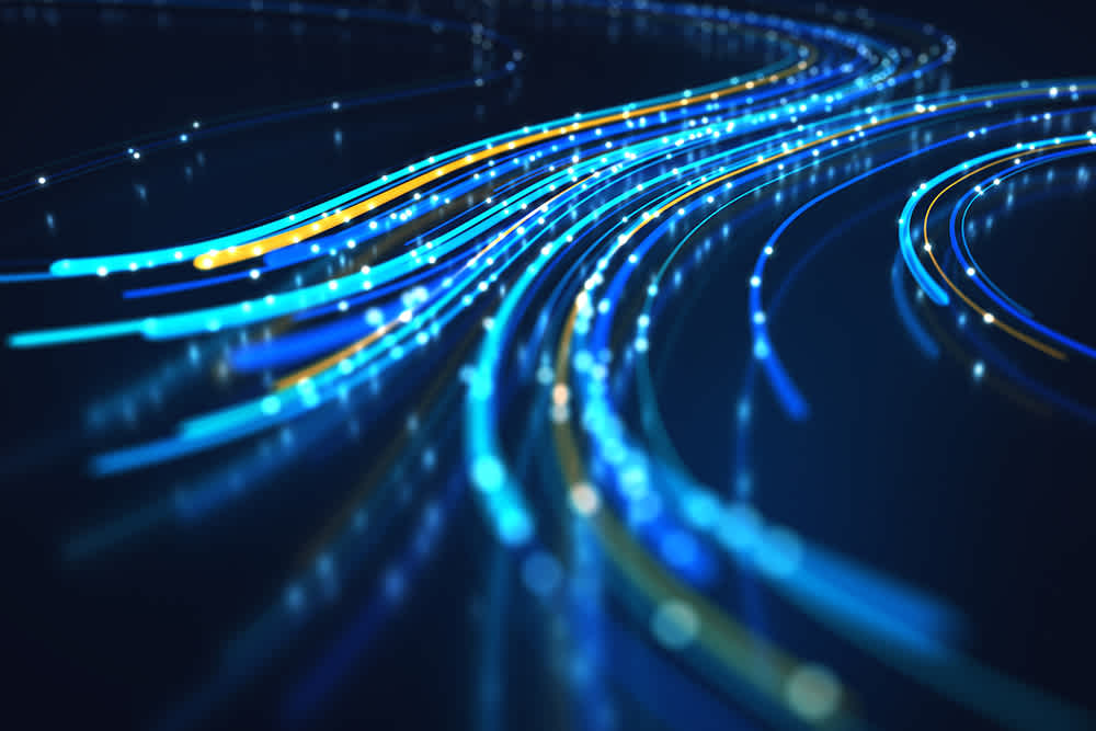 Blue and yellow glowing lines resembling fiber optic cables curve and intersect on a dark background, symbolizing data transmission or network connectivity.