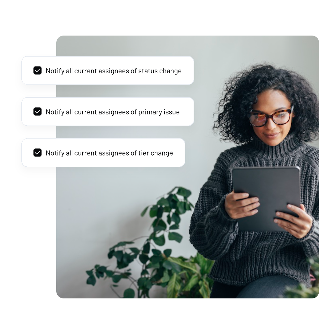 A woman with curly hair and glasses sits holding a tablet. Beside her are three notification checkboxes from NAVEX EthicsPoint from NAVEX EthicsPoint about notifying assignees of status change, primary issue, and tier change. A green plant is in the background.
