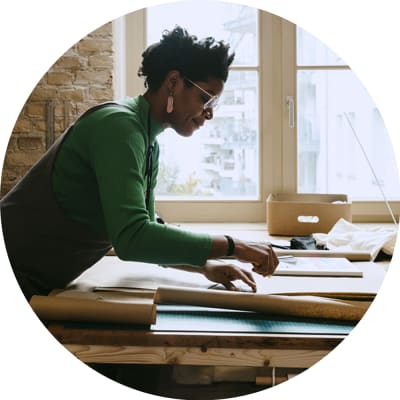 woman drafting at desk green