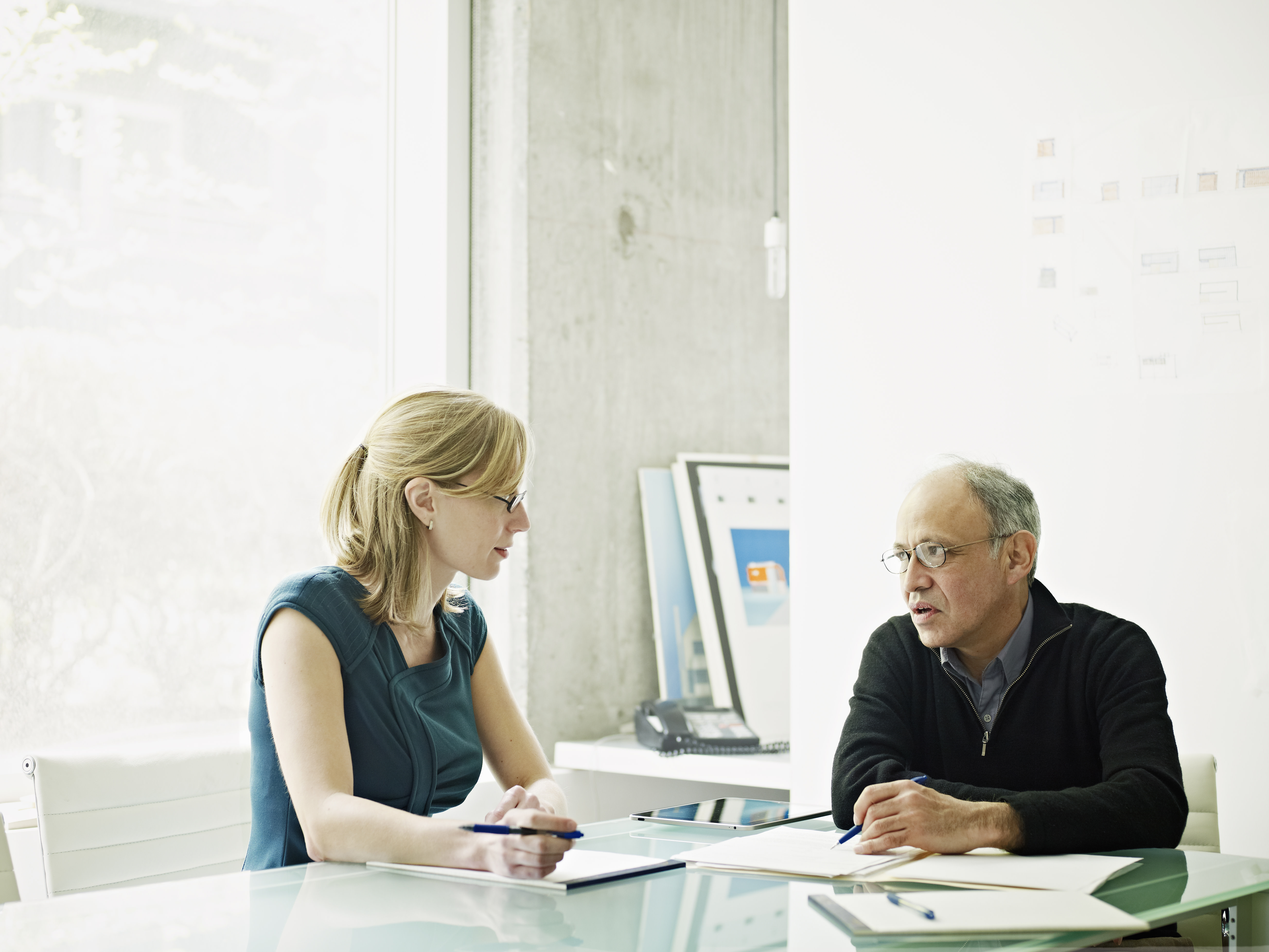 man and woman in a meeting at a conference table