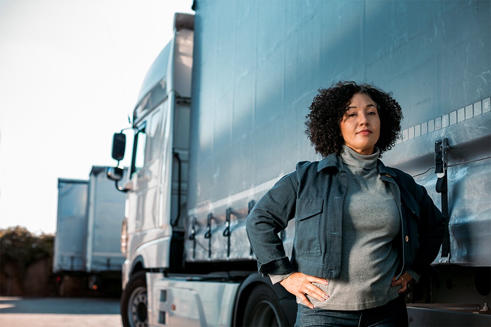Woman standing in front of semi-truck