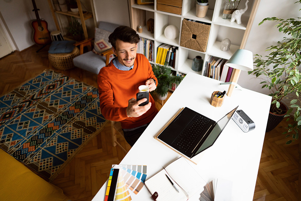 white man with mustache working in home office