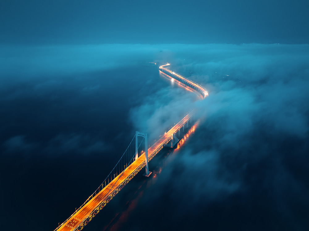 foggy waterway bridge at dusk