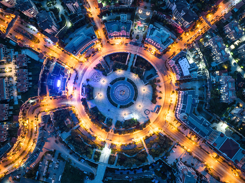 abstract image of city lights at dusk in a roundabout, taken from above