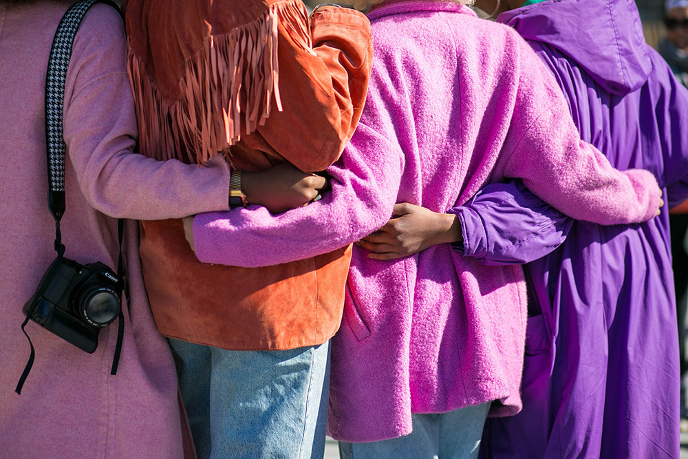 group of girls holding each other