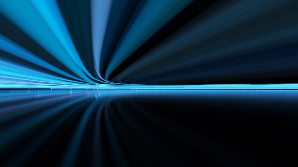 Abstract digital artwork featuring streaks of blue and black lines curving toward the horizon, reflected on a glossy, dark surface, creating a sense of speed and motion.