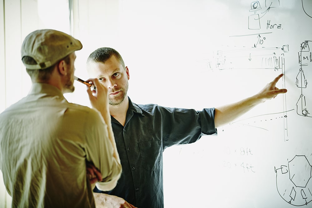 Men working on whiteboard