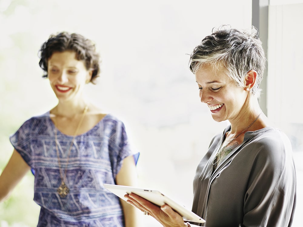 two women smiling in an office