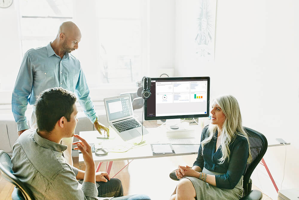 Three colleagues working together in an office