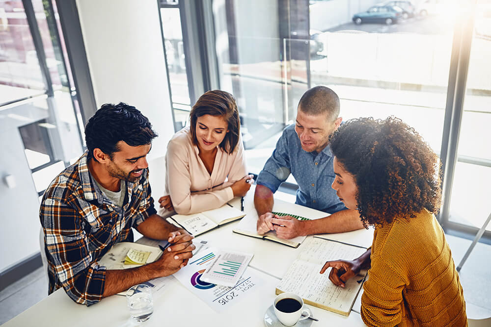 team working together at table in office 