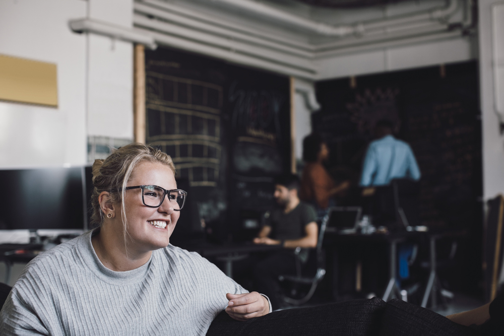 woman smiling while sitting in office