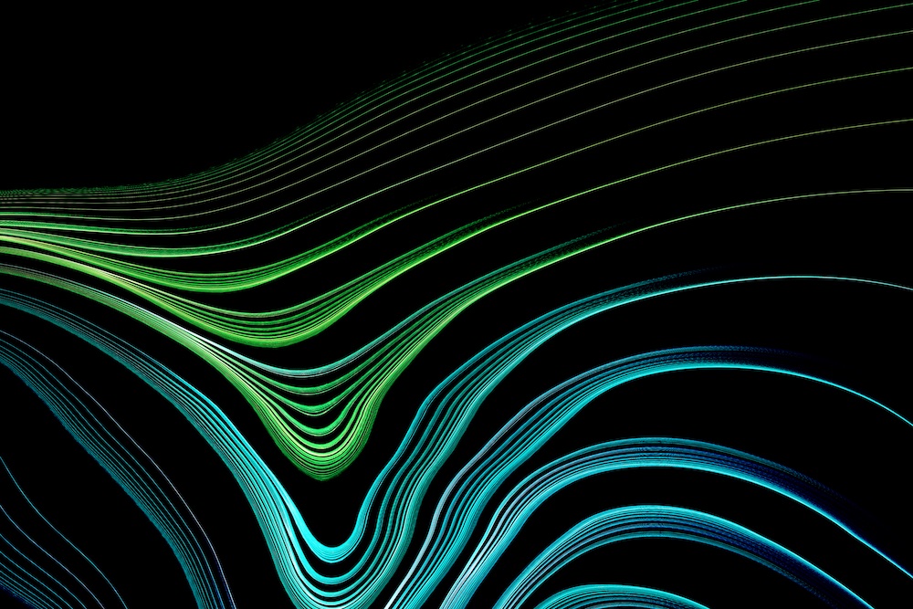 Abstract digital image with curved, glowing lines in shades of green and blue on a black background, creating a flowing, wave-like pattern.